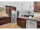Modern kitchen with stainless steel appliances, granite countertops, and adjacent dining area at 10343 Stoneflower Dr, Parker, CO 80134