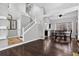 Inviting living room featuring hardwood floors, high ceilings, a staircase, and abundant natural light at 10343 Stoneflower Dr, Parker, CO 80134