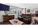 Inviting living room with leather seating, a flat screen tv, and a coffee table at 10343 Stoneflower Dr, Parker, CO 80134