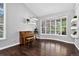 Open living room with hardwood floors, large bay window and minimalist decor, creating a spacious and inviting space at 10343 Stoneflower Dr, Parker, CO 80134