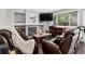 Inviting living room features a cozy fireplace, dark wood floors, and plush leather seating at 10343 Stoneflower Dr, Parker, CO 80134