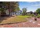 Expansive backyard featuring a lawn, mature trees, a small deck and access to the house at 10851 E Iliff Pl, Aurora, CO 80014