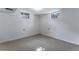 Finished basement with neutral carpet, white walls, and small windows at 10851 E Iliff Pl, Aurora, CO 80014