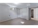 Finished basement with neutral carpet and a closet with folding doors at 10851 E Iliff Pl, Aurora, CO 80014
