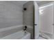 Bathroom shower featuring a tub with tiled walls and modern fixtures at 10851 E Iliff Pl, Aurora, CO 80014