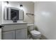 Well-lit half bathroom with a modern vanity, mirror, and fixtures, offering a clean and functional space at 10851 E Iliff Pl, Aurora, CO 80014