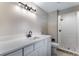 Beautifully renovated bathroom with modern sink, shower and designer tile work at 10851 E Iliff Pl, Aurora, CO 80014