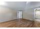 Bedroom with hardwood floors and access to the bathroom with tiled floors at 10851 E Iliff Pl, Aurora, CO 80014