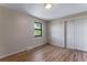 Bedroom with hardwood floors features a closet and window with natural light at 10851 E Iliff Pl, Aurora, CO 80014