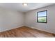Light and airy bedroom features hardwood floors and window letting in natural light at 10851 E Iliff Pl, Aurora, CO 80014