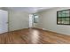 Spacious bedroom with hardwood floors, two windows and access to other rooms at 10851 E Iliff Pl, Aurora, CO 80014