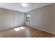 Bedroom features hardwood floors, a closet, and natural light from the window at 10851 E Iliff Pl, Aurora, CO 80014