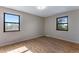 Light-filled bedroom with hardwood floors and two windows providing natural light at 10851 E Iliff Pl, Aurora, CO 80014