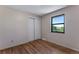 Bright bedroom features hardwood floors, closet and natural light from the window at 10851 E Iliff Pl, Aurora, CO 80014