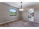 Cozy dining room featuring a modern pendant light and a large window with views of the greenery at 10851 E Iliff Pl, Aurora, CO 80014