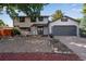 Beautiful two-story home with a two-car garage and a well-maintained, low maintenance front yard at 10851 E Iliff Pl, Aurora, CO 80014