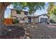 Charming two-story home with an attached two-car garage and a nicely landscaped front yard at 10851 E Iliff Pl, Aurora, CO 80014