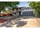 Charming two-story home featuring a two-car garage, landscaped front yard, and a welcoming entrance at 10851 E Iliff Pl, Aurora, CO 80014