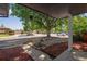 View of the front yard with mature tree providing shade, stone landscaping, and a sidewalk at 10851 E Iliff Pl, Aurora, CO 80014