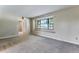 Bright living room with a window seat and neutral carpeting at 10851 E Iliff Pl, Aurora, CO 80014