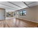 Open living space with hardwood flooring, a view into the kitchen, and a bright, airy atmosphere at 10851 E Iliff Pl, Aurora, CO 80014