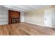 Comfortable living room featuring a cozy fireplace, built-in shelving, and warm hardwood floors at 10851 E Iliff Pl, Aurora, CO 80014