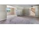 Living room with grey carpet, a dining area and stairs at 10851 E Iliff Pl, Aurora, CO 80014