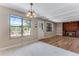 Bright living room featuring a red brick fireplace, hardwood flooring, and large windows for natural light at 10851 E Iliff Pl, Aurora, CO 80014