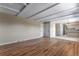 Large living room with wood floors, connecting to the kitchen, and offers ample space for furnishings at 10851 E Iliff Pl, Aurora, CO 80014