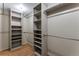 Spacious walk-in closet features wood floors, and built-in shelving at 10851 E Iliff Pl, Aurora, CO 80014