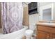 Bathroom with a tiled shower/tub combo with a decorative curtain and wooden vanity at 23465 E Platte Dr # B, Aurora, CO 80016