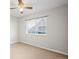 Carpeted bedroom featuring a large window and ceiling fan at 23465 E Platte Dr # B, Aurora, CO 80016