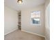 Carpeted bedroom with built-in shelves features a window that provides natural light at 23465 E Platte Dr # B, Aurora, CO 80016