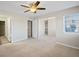 A spacious bedroom with a ceiling fan, neutral carpet, and natural light from the window at 23465 E Platte Dr # B, Aurora, CO 80016