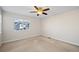 This carpeted bedroom has a window for natural light and a ceiling fan at 23465 E Platte Dr # B, Aurora, CO 80016