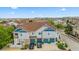 Aerial view of townhomes showcasing blue doors and trim, along with well-maintained landscaping at 23465 E Platte Dr # B, Aurora, CO 80016