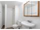 Well-lit bathroom features a vanity, toilet, and stand-up shower with tile surround at 3577 S Ouray Cir, Aurora, CO 80013