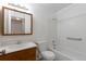 Classic bathroom with a tiled shower and bathtub combination and a sink with a wood vanity at 3577 S Ouray Cir, Aurora, CO 80013