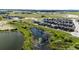 Serene aerial view of the neighborhood's pond surrounded by lush greenery and well-maintained landscapes at 947 W Beverly St, Elizabeth, CO 80107
