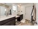 Modern bathroom showcases double sinks with dark cabinets, decorative mirror, and a walk-in shower at 947 W Beverly St, Elizabeth, CO 80107