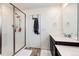 Modern bathroom featuring a walk-in shower with glass door and a single sink with ample counter space at 947 W Beverly St, Elizabeth, CO 80107