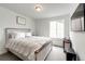 Cozy bedroom with a neutral palette, comfortable bed, and ample natural light at 947 W Beverly St, Elizabeth, CO 80107