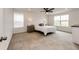 Spacious bedroom features a ceiling fan, large windows, and neutral carpet, offering a tranquil retreat at 947 W Beverly St, Elizabeth, CO 80107