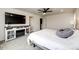 Carpeted primary bedroom with a ceiling fan, electric fireplace, and media center in neutral decor at 947 W Beverly St, Elizabeth, CO 80107