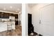 Convenient entryway area with coat rack and shoe storage, connecting to the modern kitchen at 947 W Beverly St, Elizabeth, CO 80107