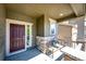 Inviting front porch with a cozy bench, stone accents, and a charming entrance door at 947 W Beverly St, Elizabeth, CO 80107