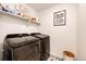 Laundry room with modern appliances, shelving, and decorative touches for convenience at 947 W Beverly St, Elizabeth, CO 80107