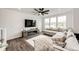This living room features a large sectional sofa, hardwood floors, and a fireplace under a wall-mounted TV at 947 W Beverly St, Elizabeth, CO 80107