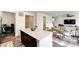 Open-concept living space with kitchen island, adjacent dining area, and comfortable seating at 947 W Beverly St, Elizabeth, CO 80107