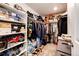 Organized walk-in closet filled with clothing and shoes on shelves and hanging rods for optimal storage at 947 W Beverly St, Elizabeth, CO 80107